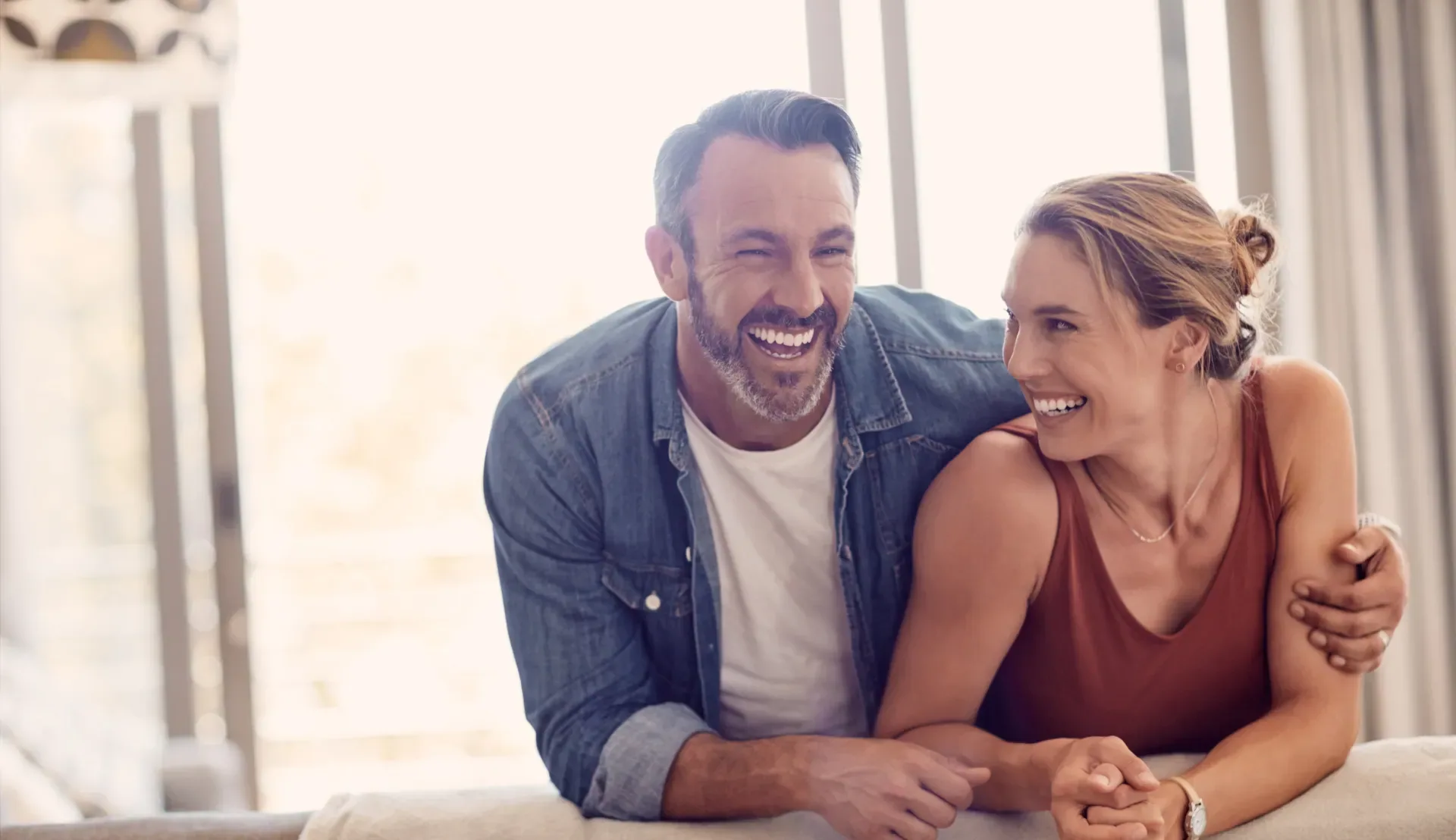A smiling couple sharing a moment at home